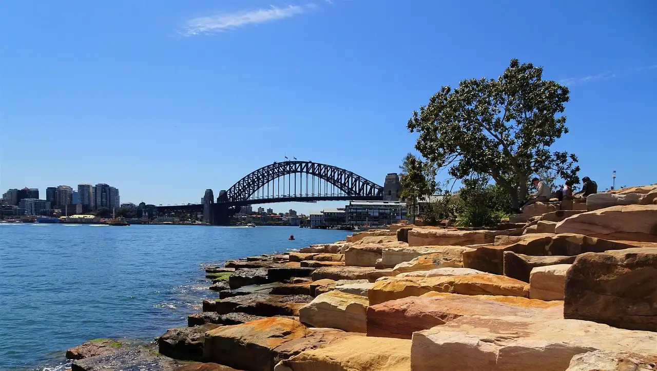 Sandstone blocks on the harbour shore at Barangaroo, with the Harbour Bridge in the distance