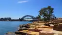 Sandstone blocks on the harbour shore at Barangaroo, with the Harbour Bridge in the distance