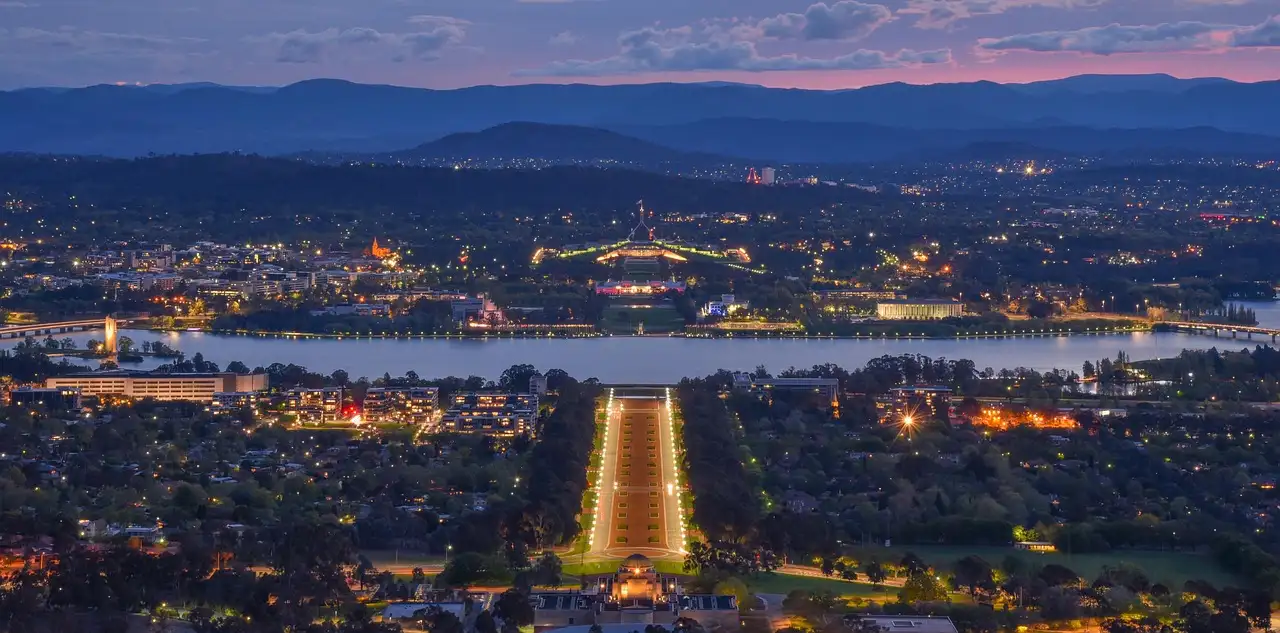 Canberra at dusk seen from Mount Ainslie, with Anzac Parade leading to the lake