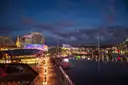 Darling Harbour in the evening, with lit restaurants along the waterfront and boats at the quay