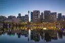 Darling Harbour at blue hour, city towers and Sydney Tower reflected in the calm water of Cockle Bay