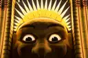 The glowing smiling face entrance of Luna Park with its gold sunburst