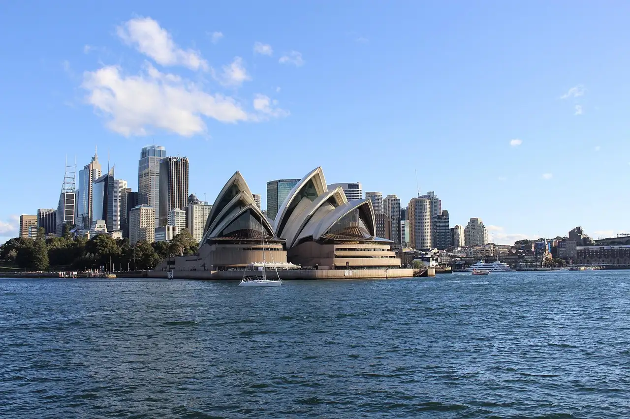 The Sydney Opera House and the city skyline seen from the harbour on a sunny day