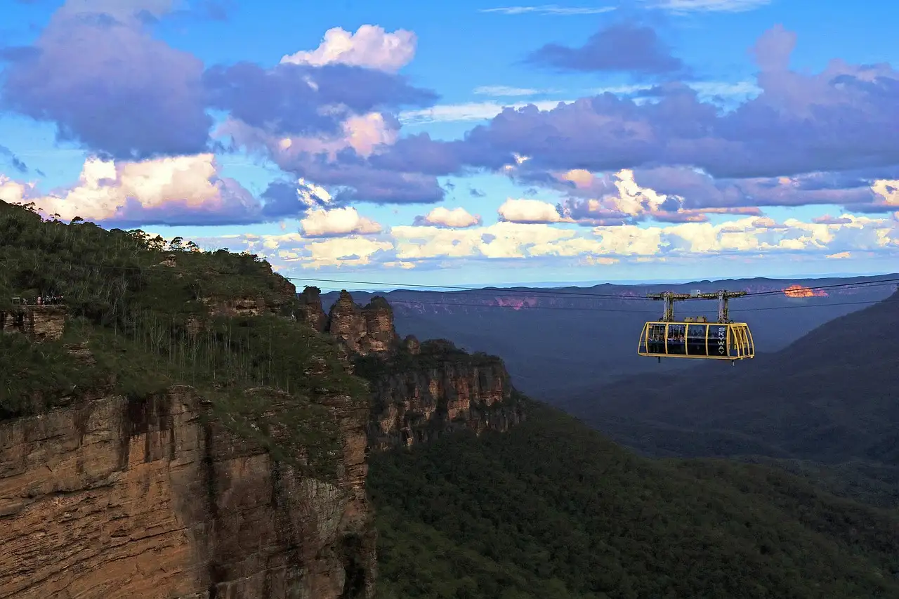 A cable car cabin crossing high above a forested valley in the Blue Mountains