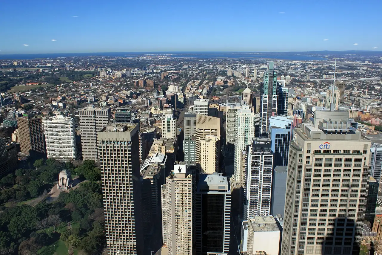 Sydney's city centre seen from high above, with parks and the suburbs spreading to the horizon