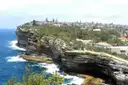 Sandstone sea cliffs at The Gap near Watsons Bay, Sydney, with waves breaking below and houses on top